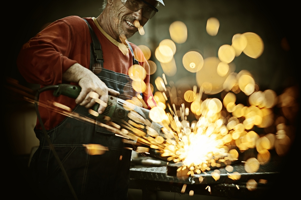 Man using a tool creating sparks